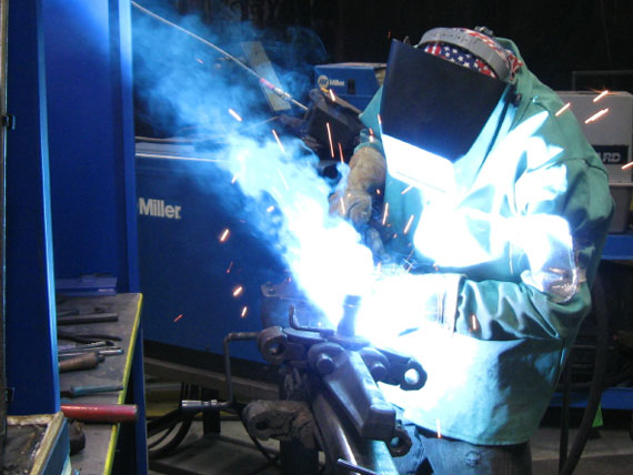 Welding smoke Environmental Booth with work and employee next to booth venting away fumes Industrial and commercial environmental booths in factories
